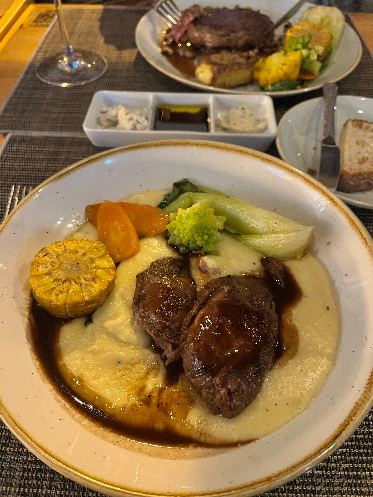 Slow-cooked beef cheeks in red wine jus on creamy mashed potato with corn, carrot, romanesco and pak choi at Laranjinha Bistro & Grill in Caniço, Madeira