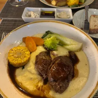 Slow-cooked beef cheeks in red wine jus on creamy mashed potato with corn, carrot, romanesco and pak choi at Laranjinha Bistro & Grill in Caniço, Madeira
