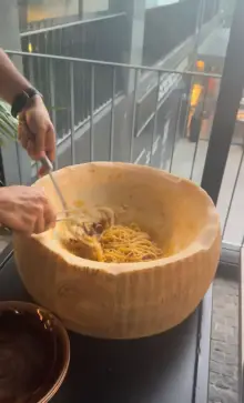 Fresh pasta tossed tableside in a giant cheese wheel at Lucca Italian Cuisine, Funchal