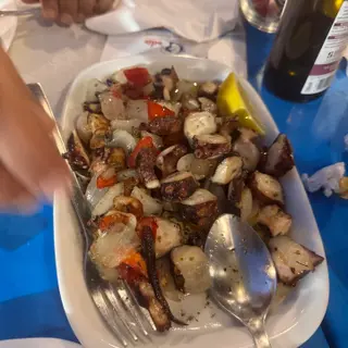 Octopus salad with onions, red peppers and a lemon wedge at Nova Onda Cantinho dos Petiscos in Caniço de Baixo, Madeira