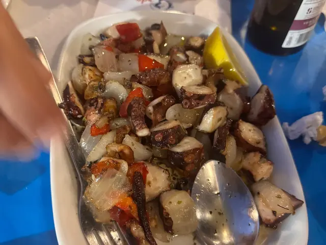 Octopus salad with onions, red peppers and a lemon wedge at Nova Onda Cantinho dos Petiscos in Caniço de Baixo, Madeira