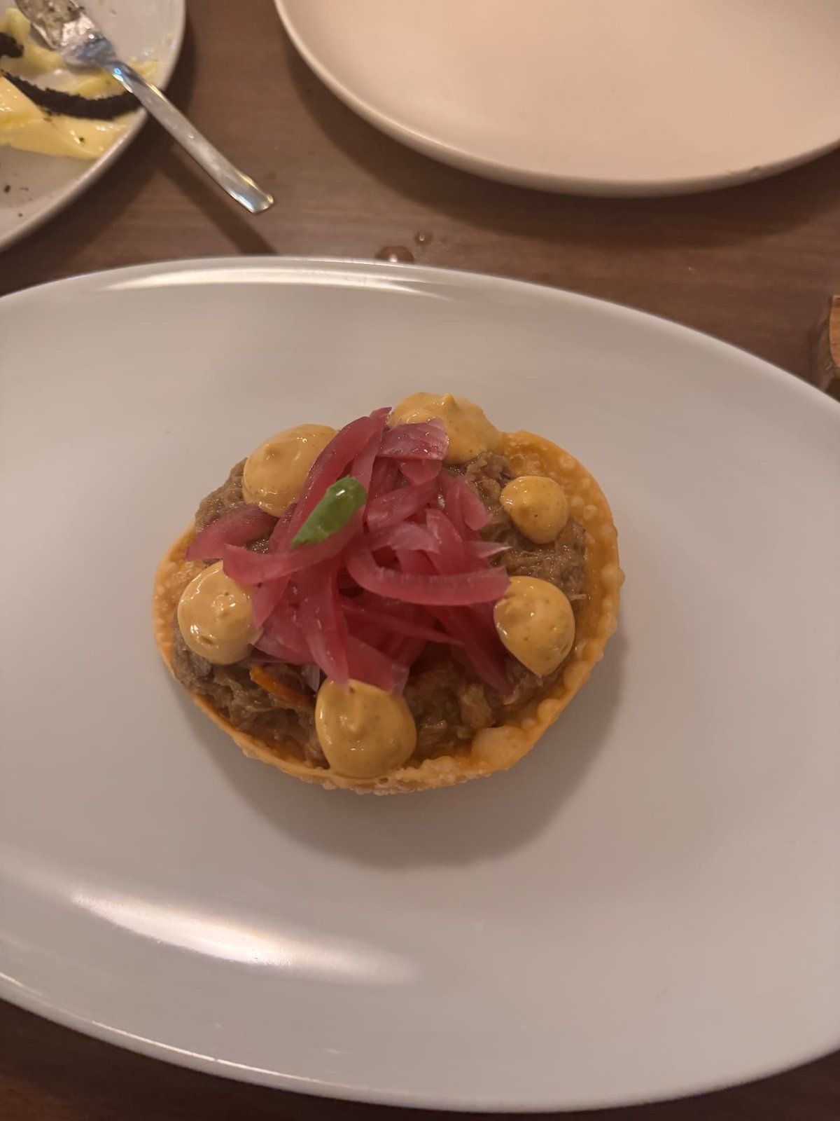 Shredded meat tartlet starter with pickled red onion and mustard cream at Theos restaurant, Funchal, Madeira