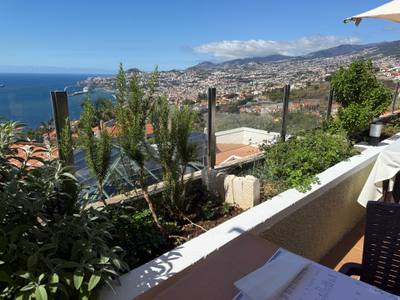 Table with a view of Funchal bay on the terrace at O Zarco restaurant