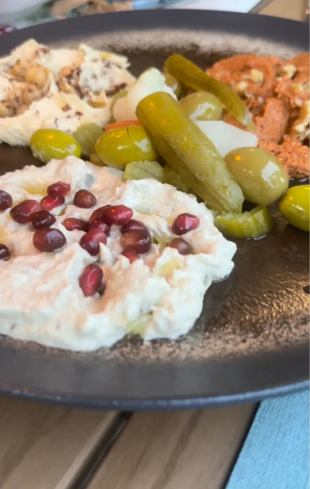 Meze platter at Zaytun Funchal — labneh with pomegranate, olives, pickles and muhammara