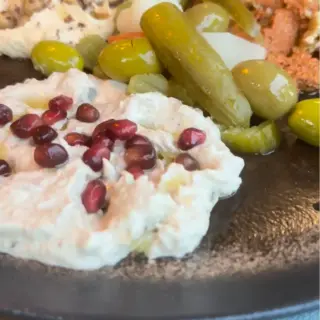 Meze platter at Zaytun Funchal — labneh with pomegranate, olives, pickles and muhammara