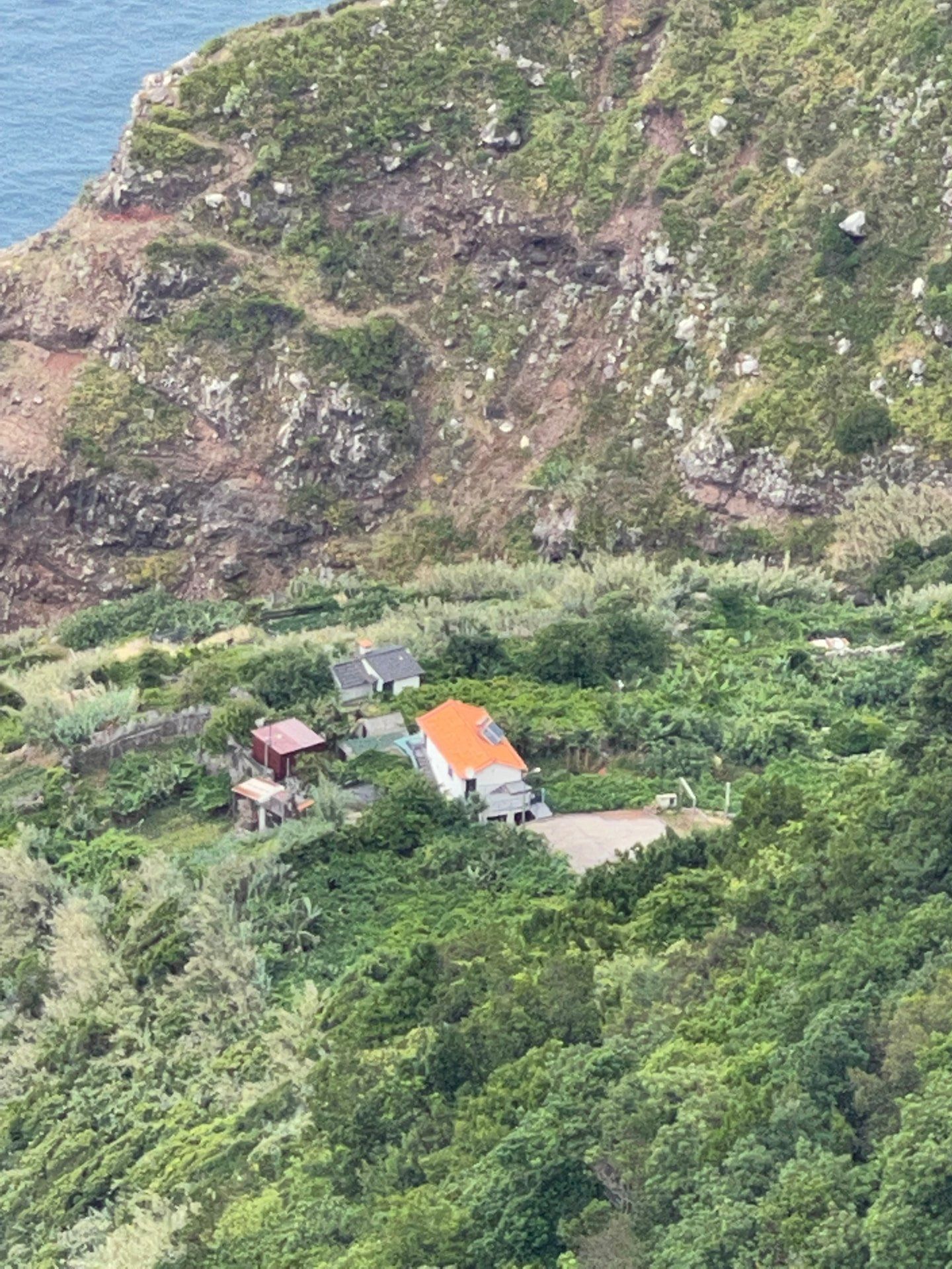 Isolated clifftop house and banana terraces below Arco de Sao Jorge, Madeira