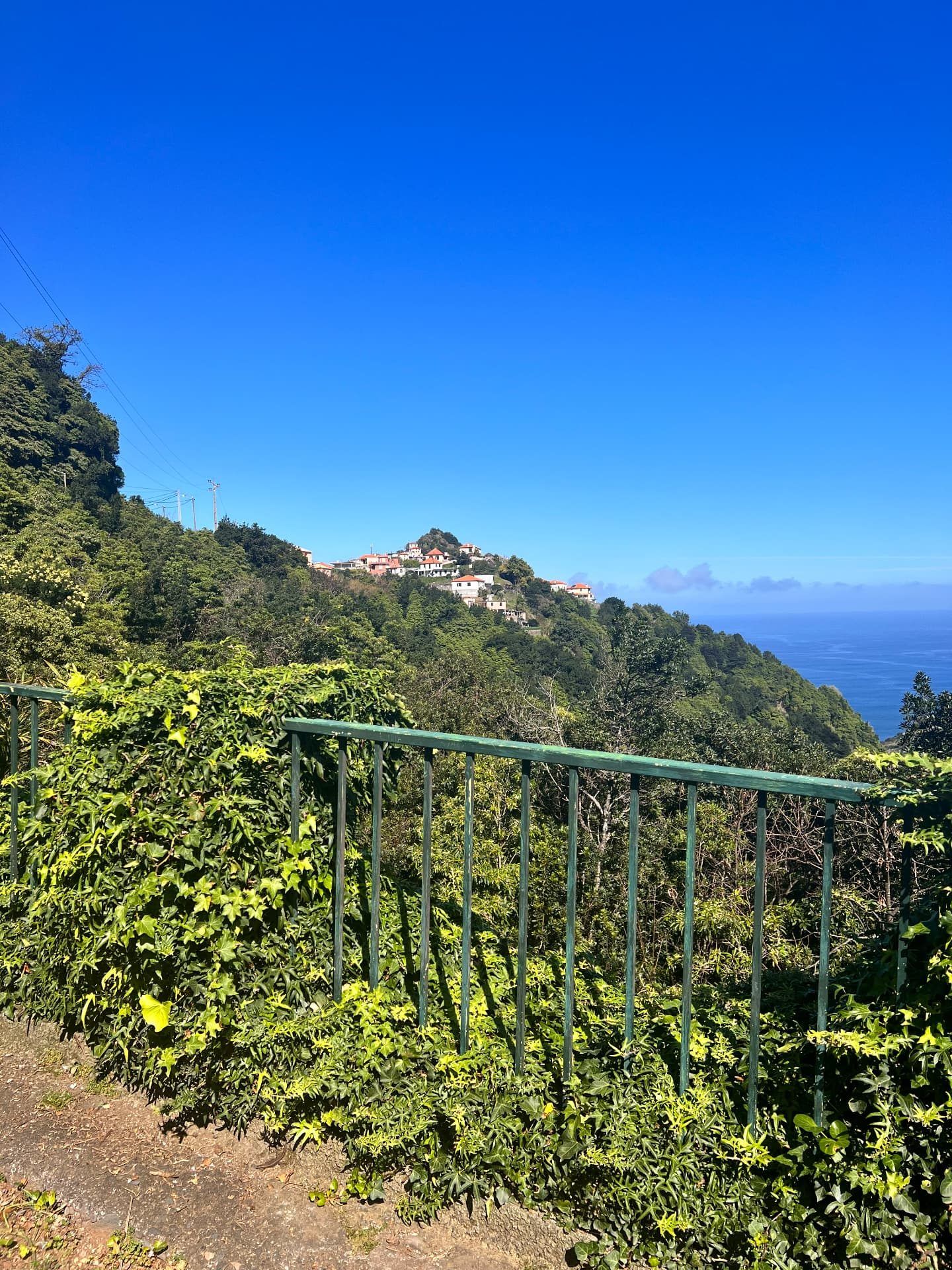 Boaventura village houses on the hilltop seen from the viewpoint path, Madeira north coast
