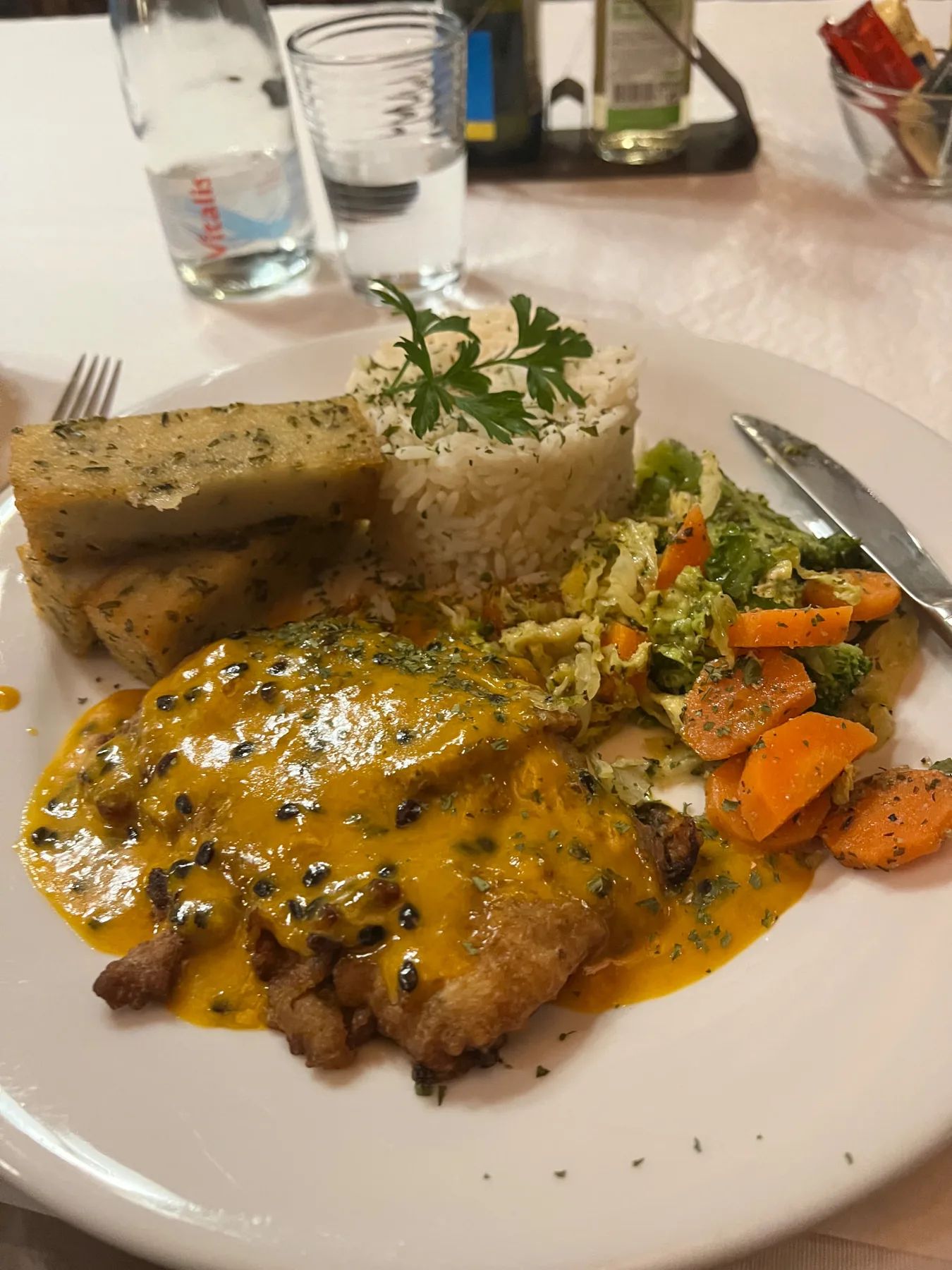 Chicken in passion-fruit sauce with rice, milho frito and vegetables at a Santana restaurant