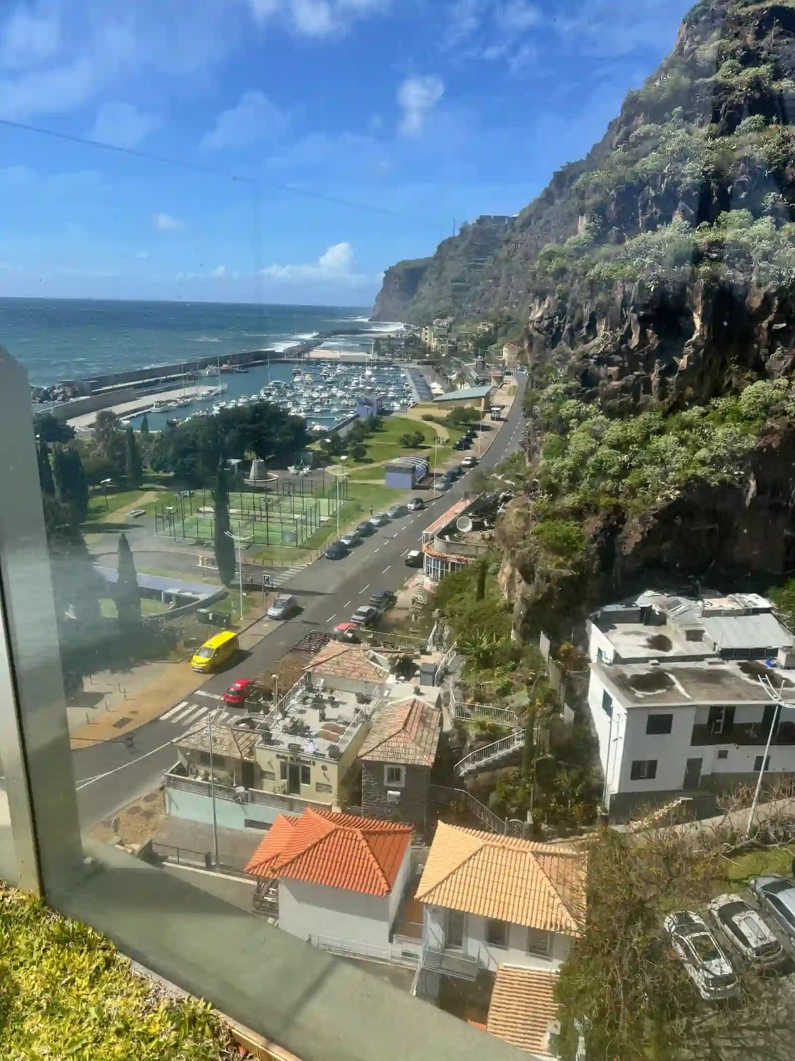 View over Calheta marina, the coastal road and the cliffs below the town