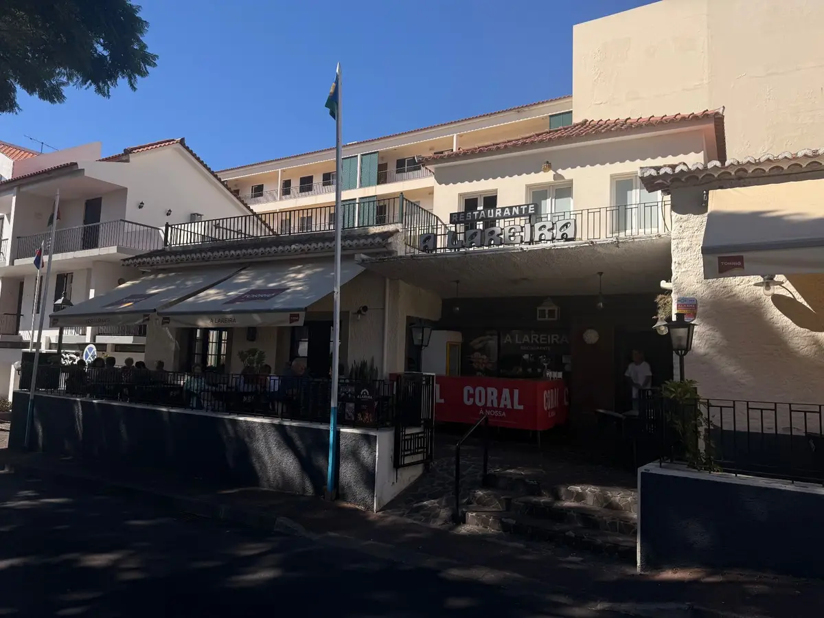 Restaurante A Lareira on Caniço town square with diners on the shaded terrace, Madeira