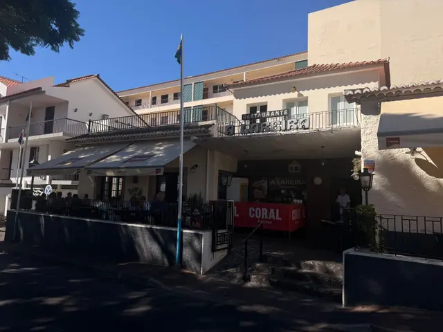 Restaurante A Lareira on Caniço town square, with diners on the shaded terrace