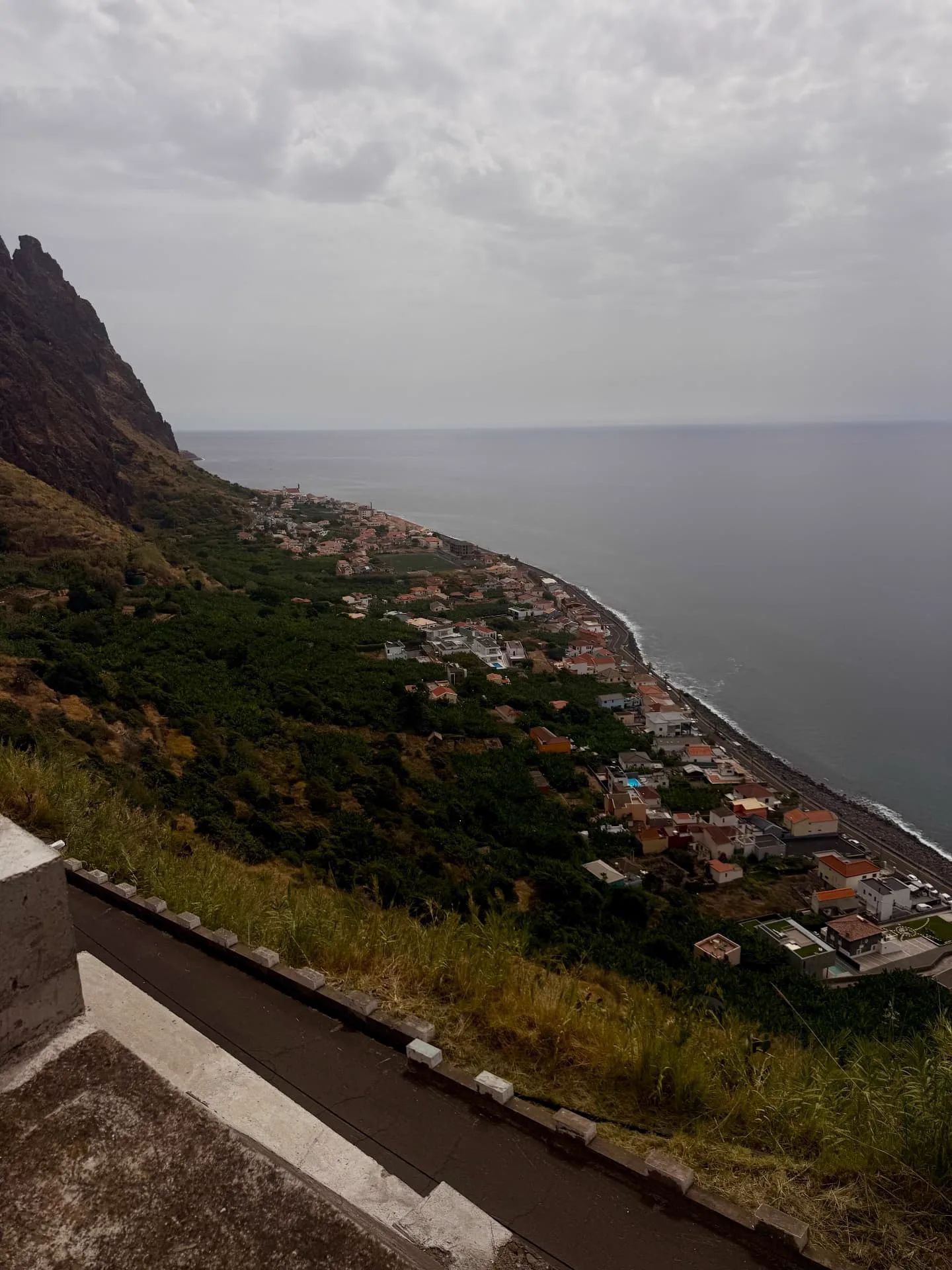 Looking down on Paul do Mar, its church and football pitch, with cliffs on the left