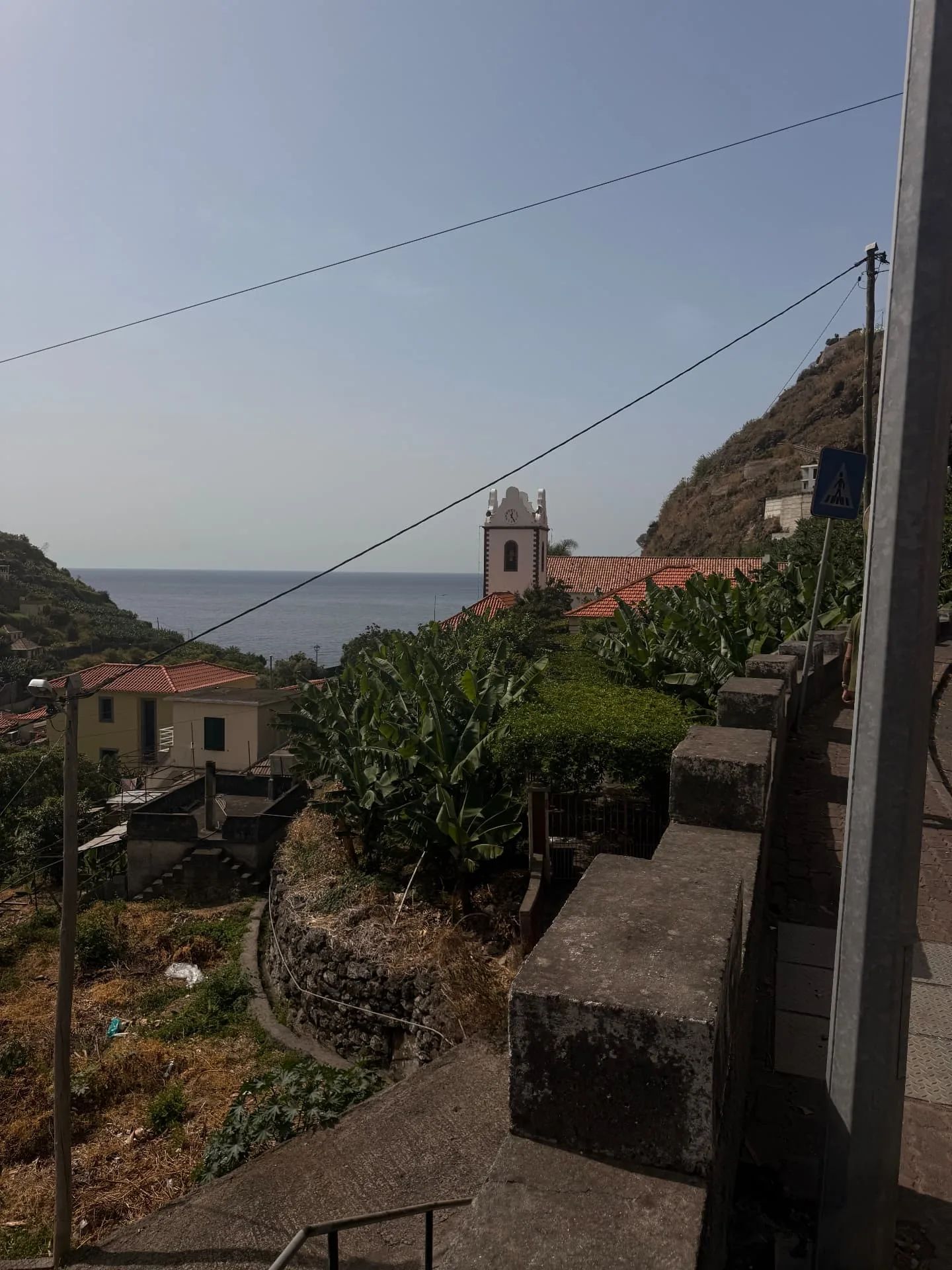 Tabua church bell tower and the sea seen from the road above the village