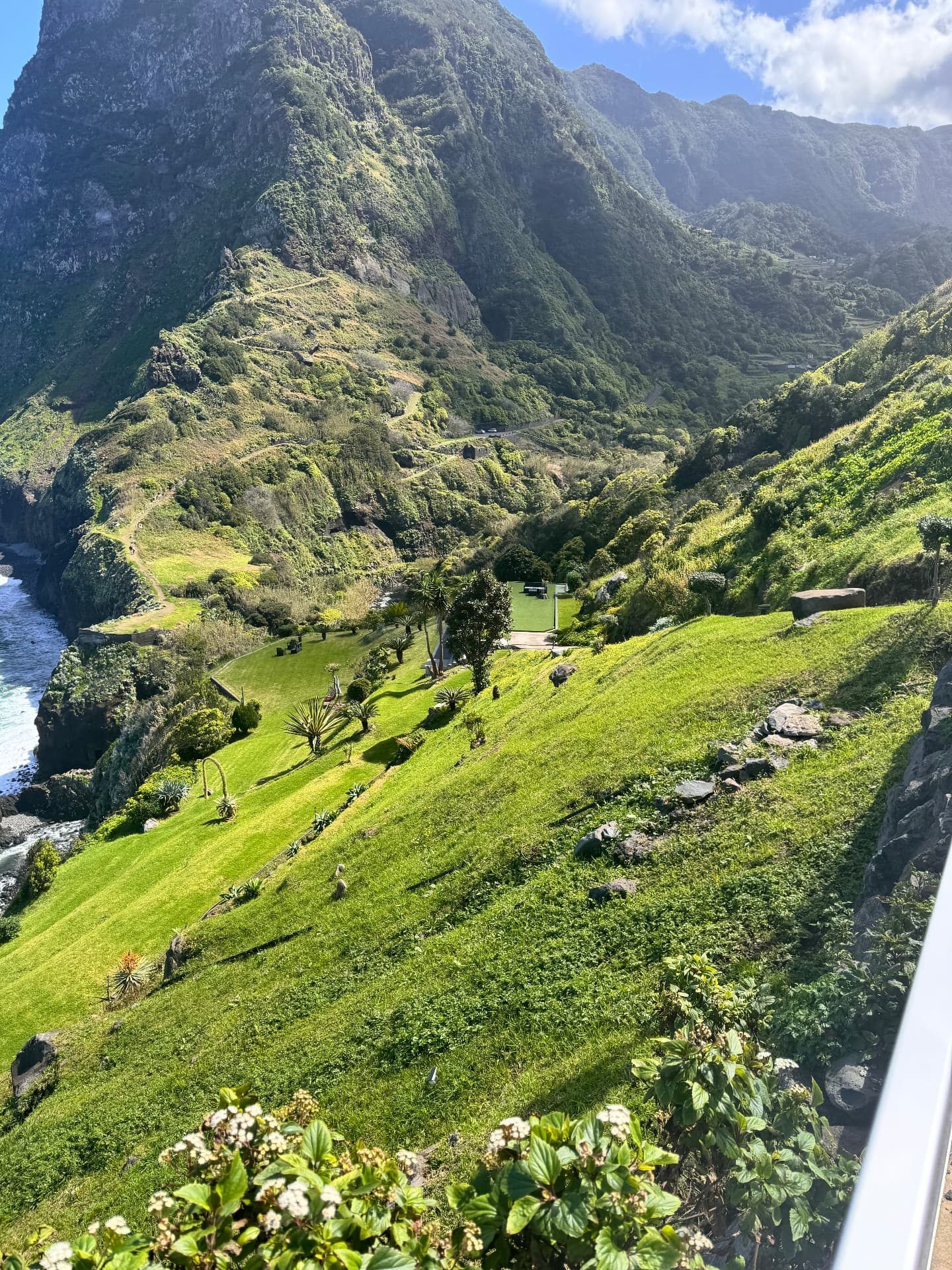 Lawns and garden terraces below Miradouro de São Cristóvão under the Boaventura cliffs