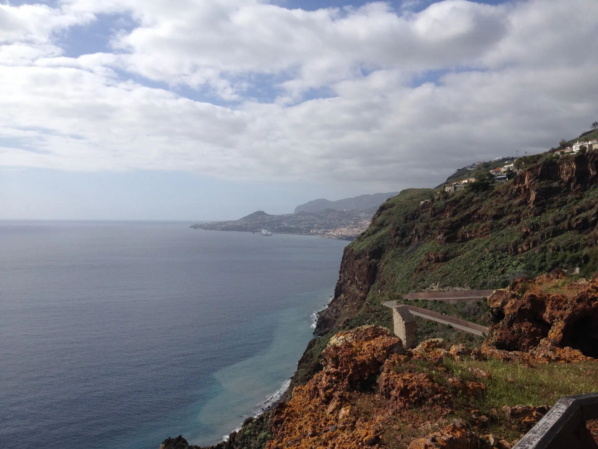 View west along the cliffs from Cristo Rei towards Funchal bay and a cruise ship in port