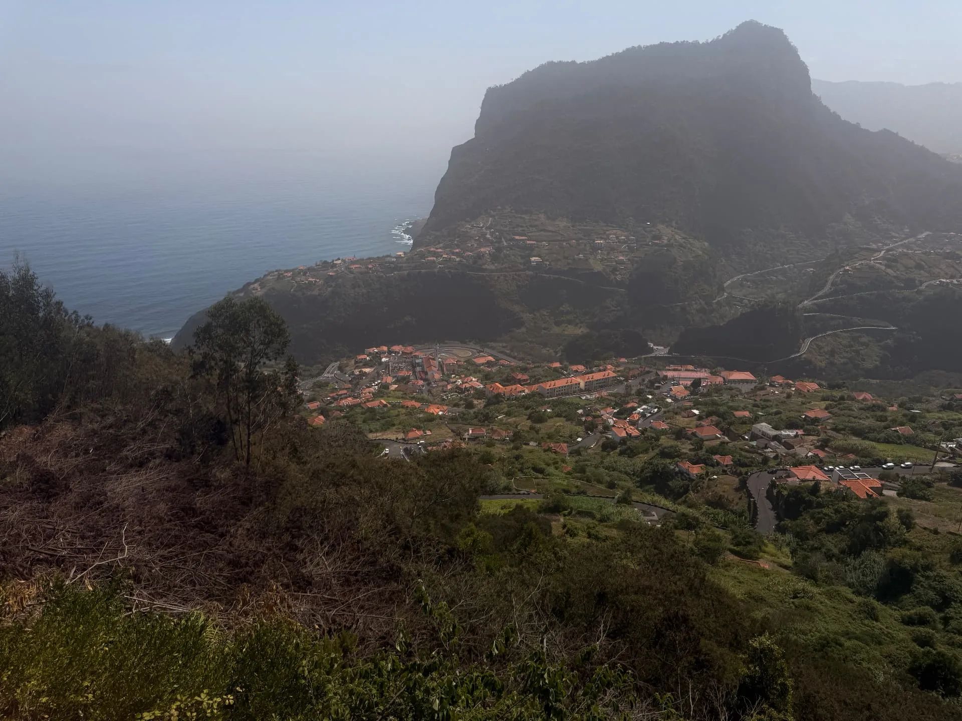 View from Miradouro do Curtado across Faial village to Penha de Águia and the Atlantic Ocean.