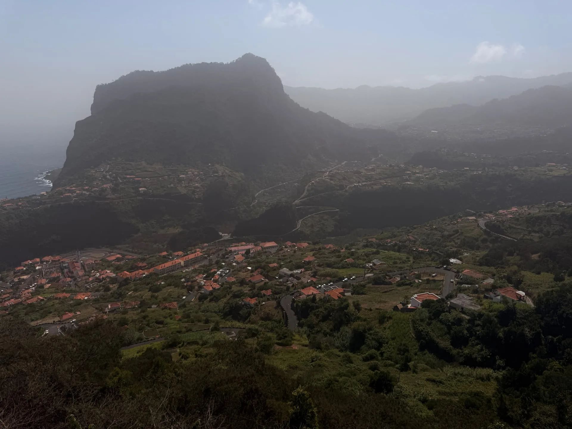 Faial’s houses and terraced slopes below Penha de Águia, seen from Miradouro do Curtado.