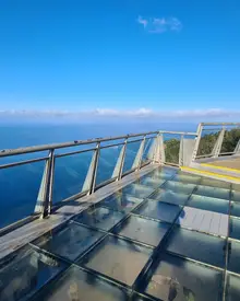 Glass floor panels of the Cabo Girão skywalk with the Atlantic 580 m below and blue sky above, Madeira